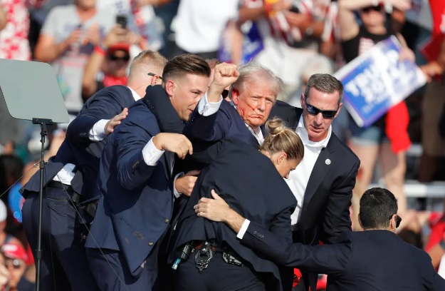 Agentes del Servicio Secreto de EE. UU. sacan al expresidente Donald Trump del lugar del atentado.